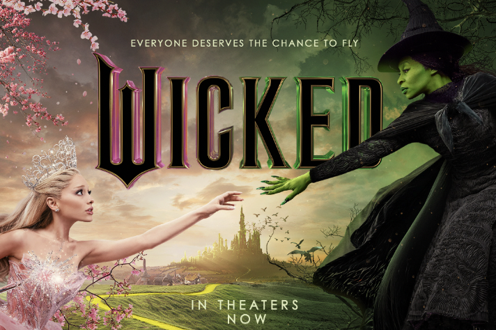 A promotional poster depicts Glinda, the Good Witch (Ariana Grande), and Elphaba (Cynthia Erivo) reaching towards each other. "Wicked" follows the relationship between Glinda and Elphaba as they navigate adversity and face discrimination. (Photo Credit: Universal Pictures.)